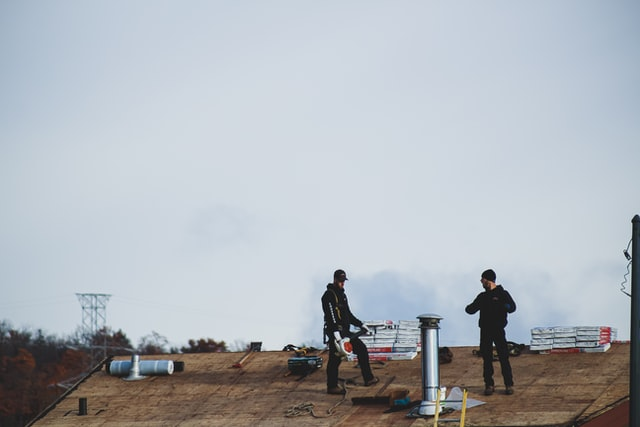 Professional roofing contractors in the US repairing a roof