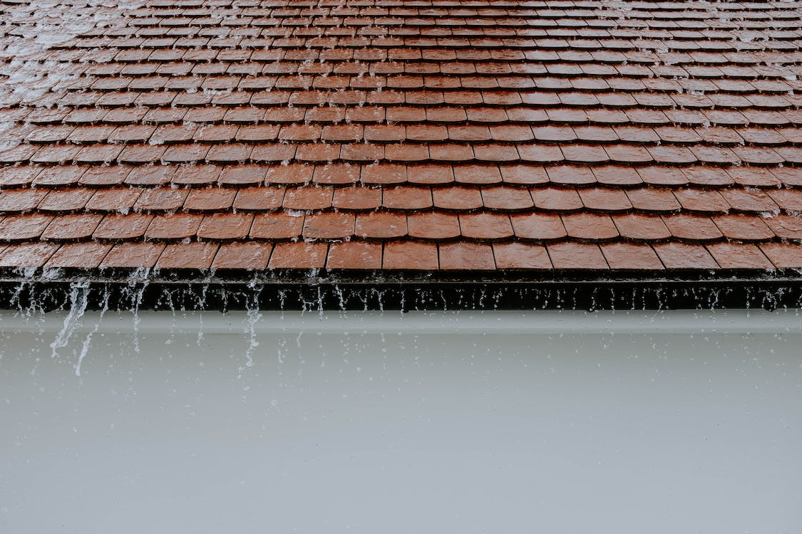  a shingle roof under the rain